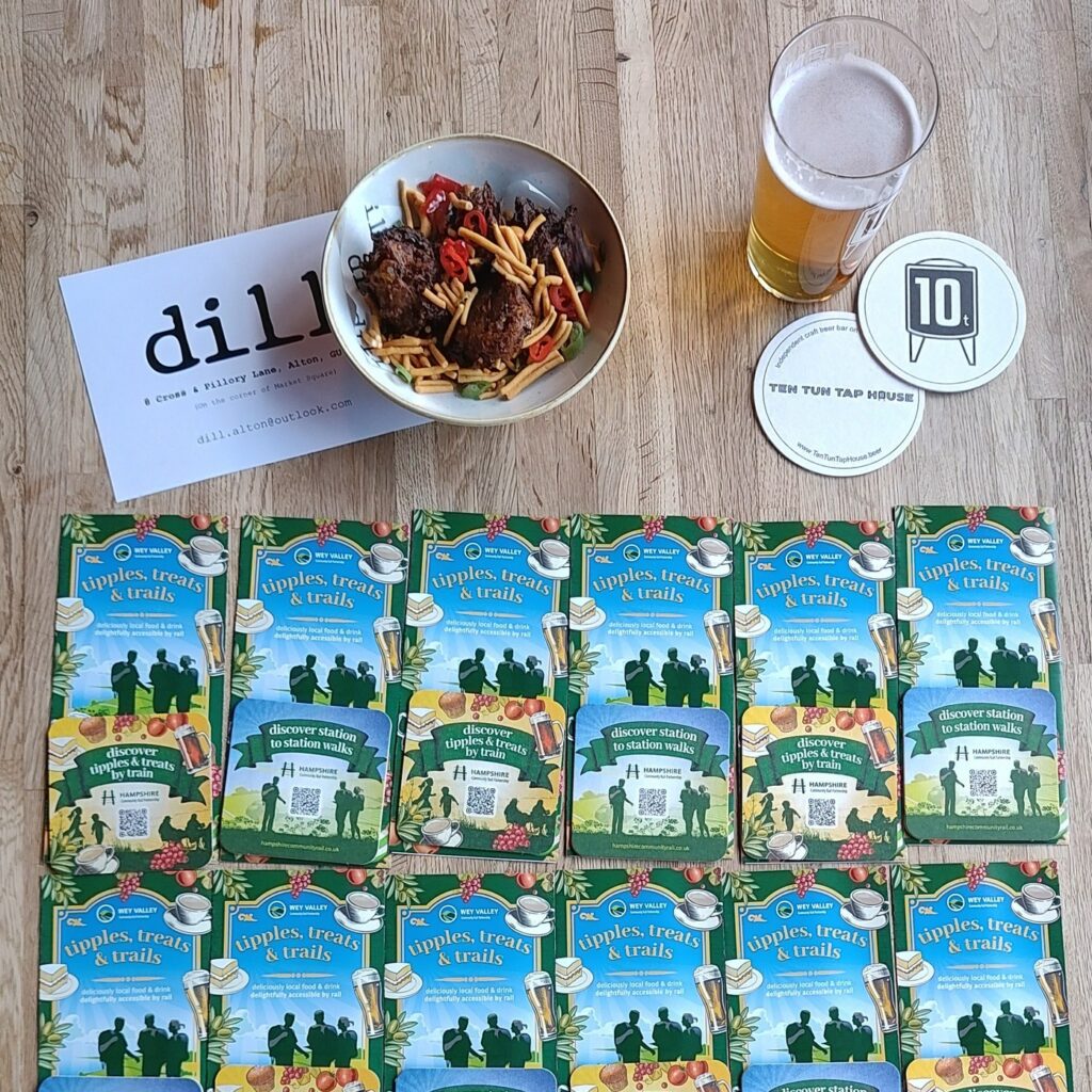 Photo of a pint, nibbles and the trail leaflets on a table.