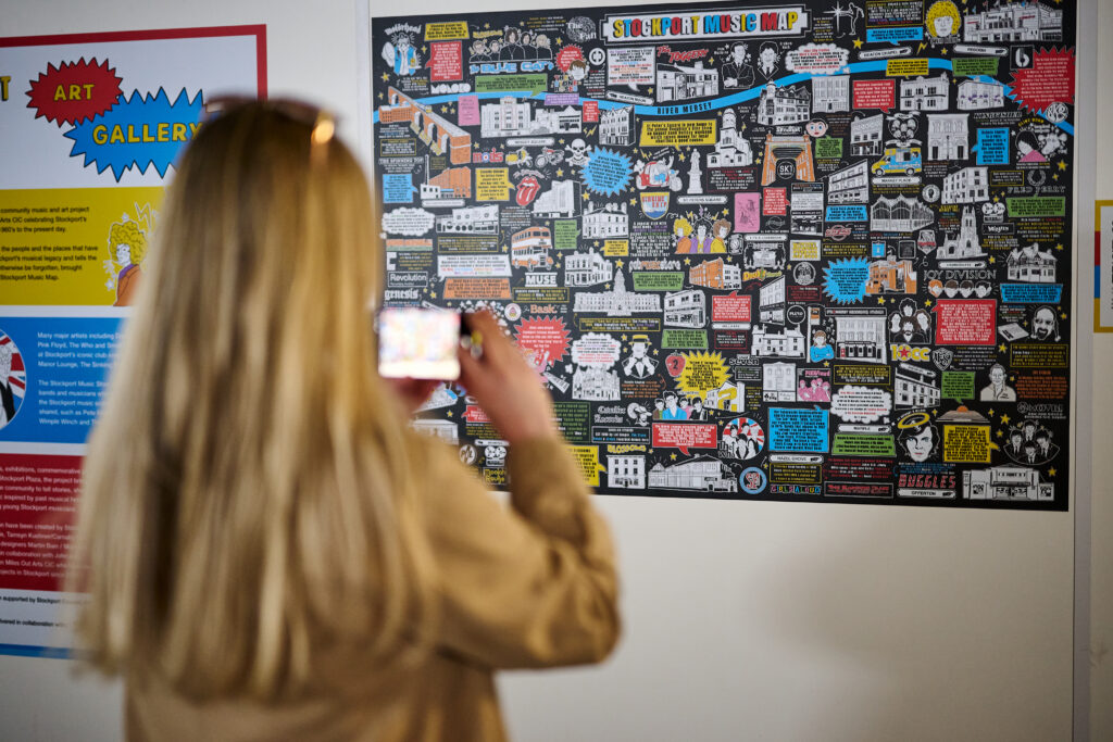 Person taking photo of Stockport Music Map.