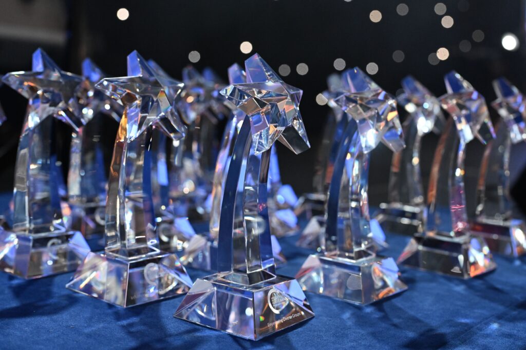 A table of glass awards shaped like shooting stars.